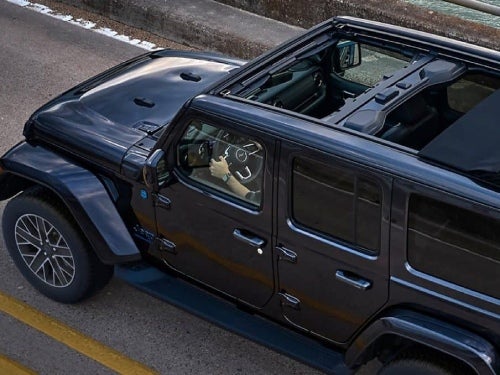 2024 Jeep Wrangler 4xe overhead view of vehicle driving down the road