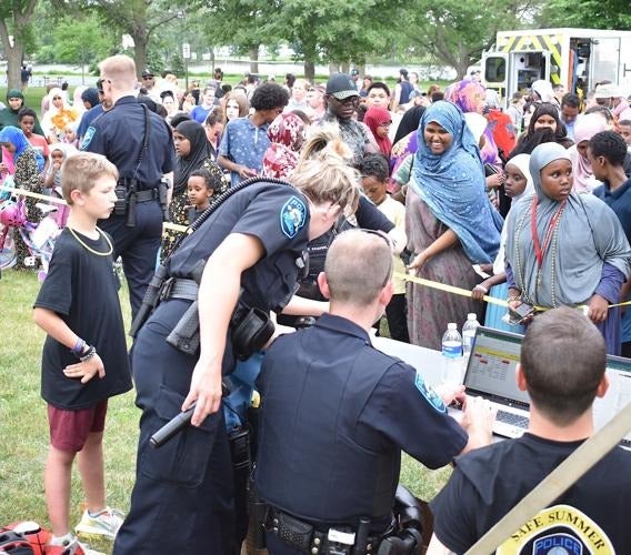 Faribault residents observing a demonstration of police work at the Safe Summer Kickoff