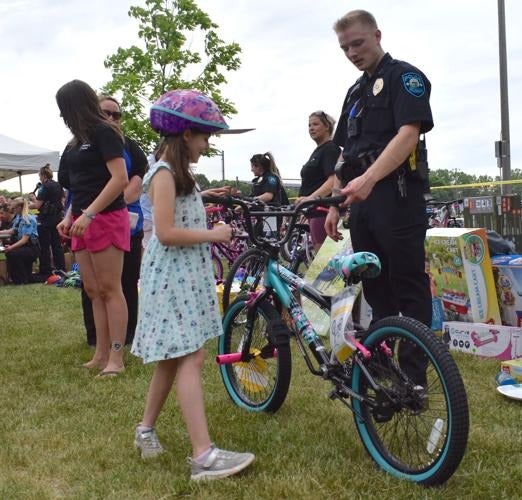 Faribault police officer gifting a child a new bike