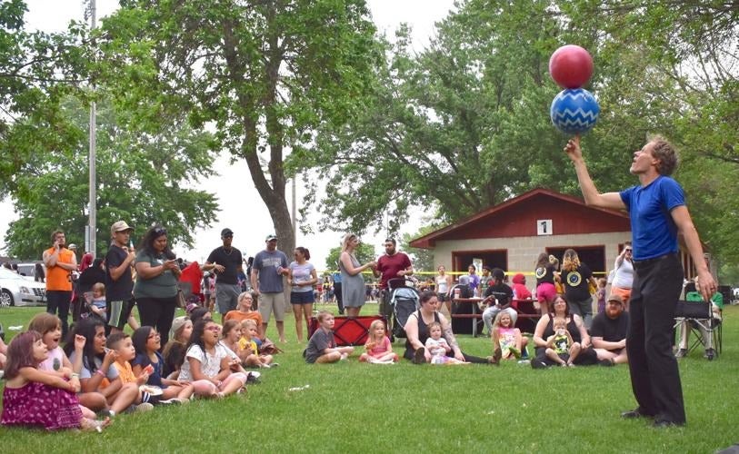 Faribault residents observing a performer at the Safe Summer Kickoff