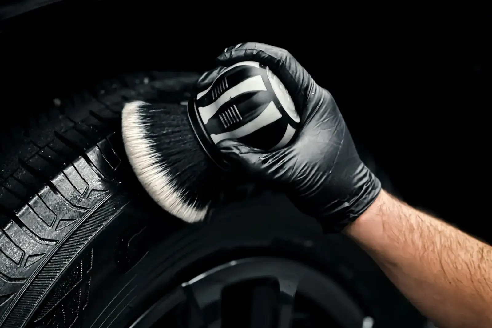Car Detailer cleaning a wheel