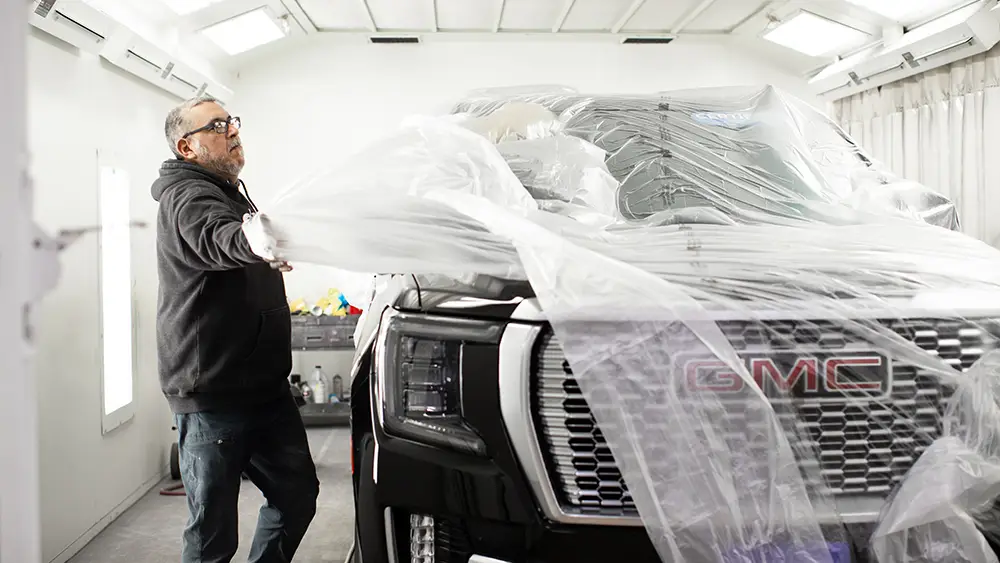 Abra Collision technician prepping a car for paint